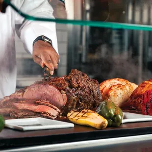 a chef slicing meat on a cutting board