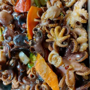 a plate of octopus and vegetables