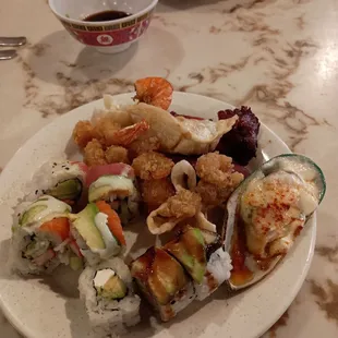a plate of sushi and rolls