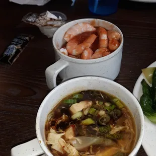 Hot and Sour soup in front and boiled shrimp with cocktail sauce in a mug in back!