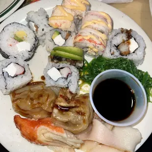 Sushi, seaweed salad, cheesy crabmeat and gyoza.