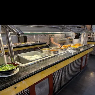 a man preparing food at a buffet