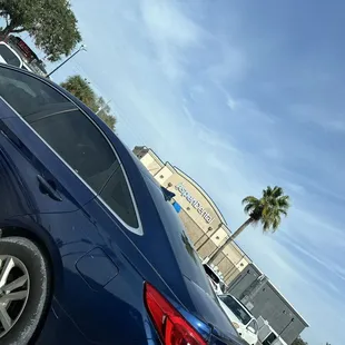 a blue car parked in a parking lot