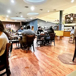 people sitting at tables in a restaurant