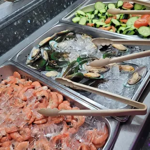 a variety of seafoods in a buffet