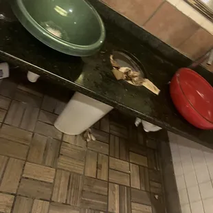 a green bowl and a green bowl on a black countertop