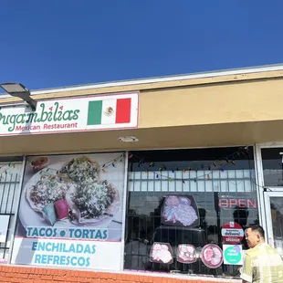 a woman walking past a mexican restaurant
