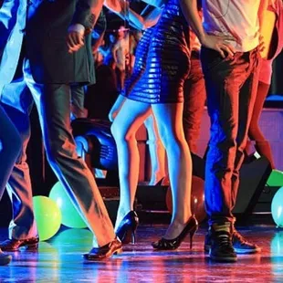  a group of people dancing on a dance floor