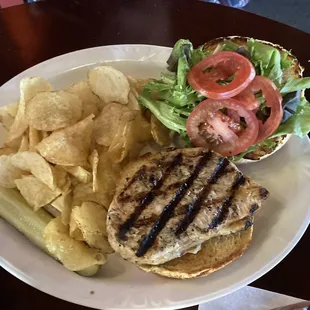 a burger and chips on a plate