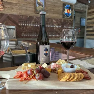 Charcuterie board and a bottle of our favorite wine. Velvet Red Blend 2023.