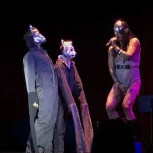 three men in costumes