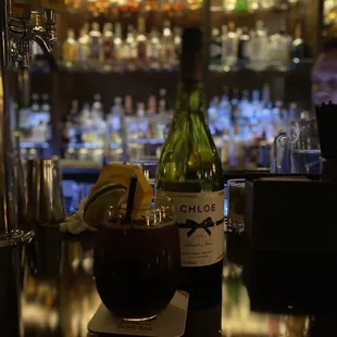 a bottle of alcohol and a glass of wine