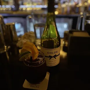 a drink and a bottle of wine