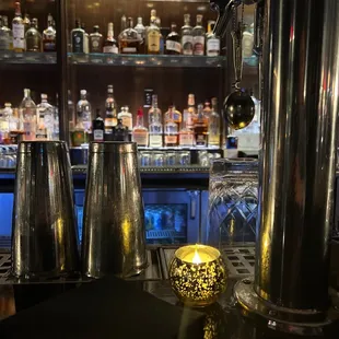 a row of liquor bottles behind a bar