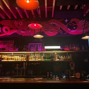 a bar with a lot of bottles on the counter