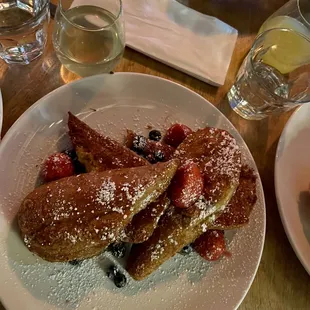 PAN FRITO  French roll soaked in egg wash with cinnamon and vanilla deep fried served with berries.