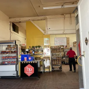 a man walking through a bakery