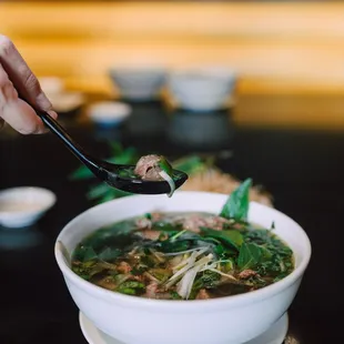 a bowl of soup with meat and vegetables
