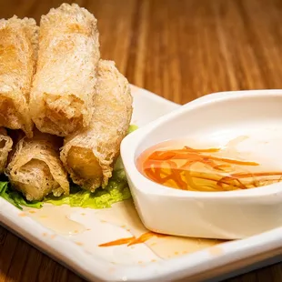 a plate of food with dipping sauce