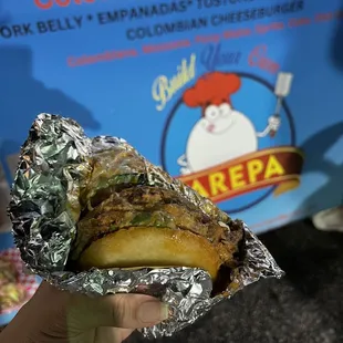 a person holding a sandwich