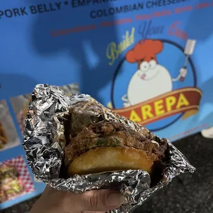 a person holding a sandwich