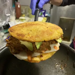 Doble Arepa de Choclo Con Carne Desmechada. Double Sweet Arepas with Shredded Beef.