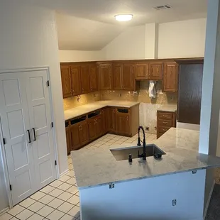 a kitchen with a sink and a refrigerator