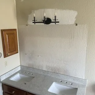 a bathroom with two sinks and a mirror