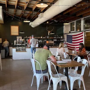 people sitting at tables in a coffee shop