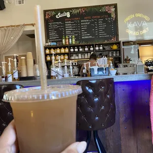 a hand holding a cup of coffee