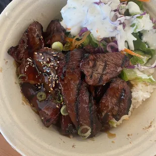 Beef poke bowl and rice, with a small salad. Tasted very good, and worth taking home the excess.