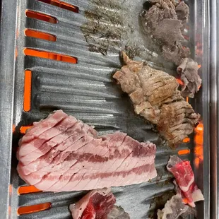 meat being cooked on a grill