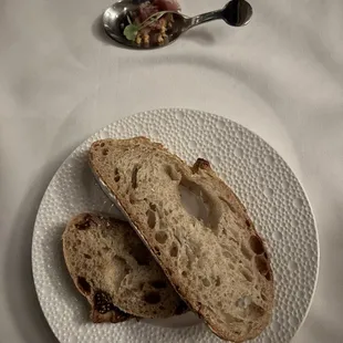 two slices of bread on a plate with a spoon