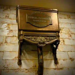 an antique toilet with a brass finish