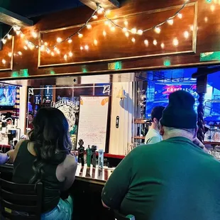 a group of people sitting at a bar