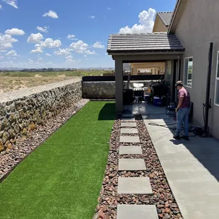 Customs back yard design. Squares cement steps. Porch slab. Artificial grass. River rock.