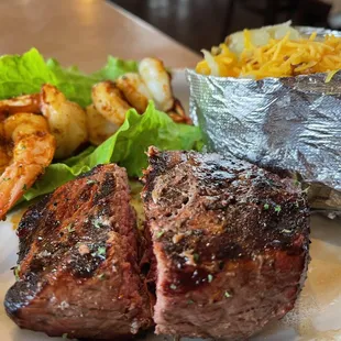 Sirloin steak, baked potatoes, grilled shrimp.