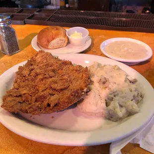 Lunch portion of chicken fried steak and mashed potatoes.