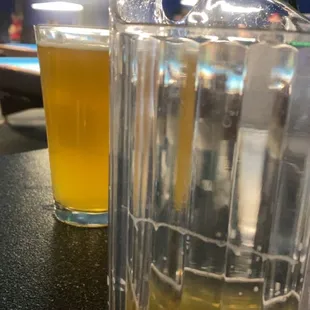 a pitcher of beer and a glass of beer