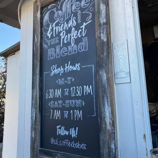 a chalkboard sign for a coffee shop