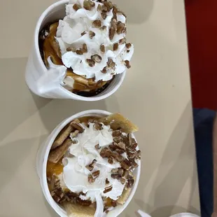 two bowls of dessert with whipped cream