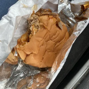 a sandwich wrapped in aluminum foil