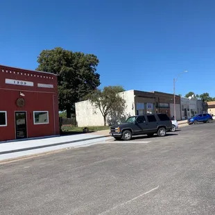 a red building and a black truck
