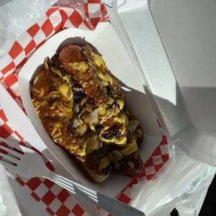 Chili cheese dog with onions and mustard