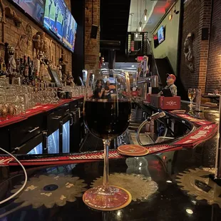 a glass of wine on a bar