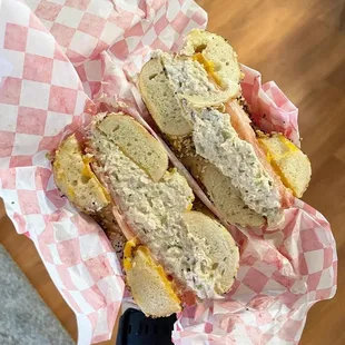 a hand holding a sandwich