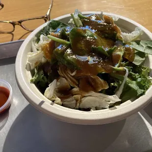 Bowl with sushi rice, beef boolgogi, spicy chicken, a bunch of veggies, boolgogi sauce, sesame oil, and boolgogi sauce. SO GOOD!