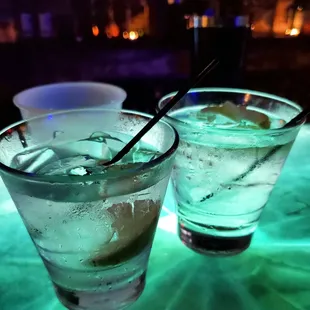 two glasses of water with ice and a slice of lemon