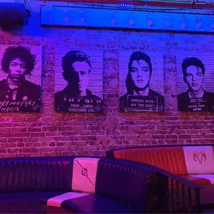 a brick wall with posters on it