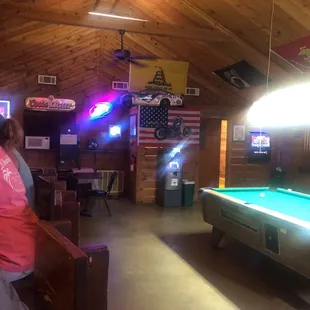 a woman sitting at a pool table